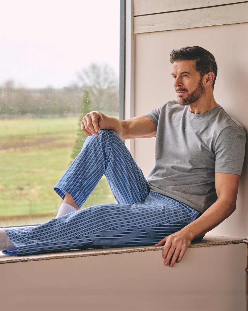 Grey Blue Coloured HJ Hall Mens Crew Neck T-Shirt And Long Pyjamas Set on indoor background 