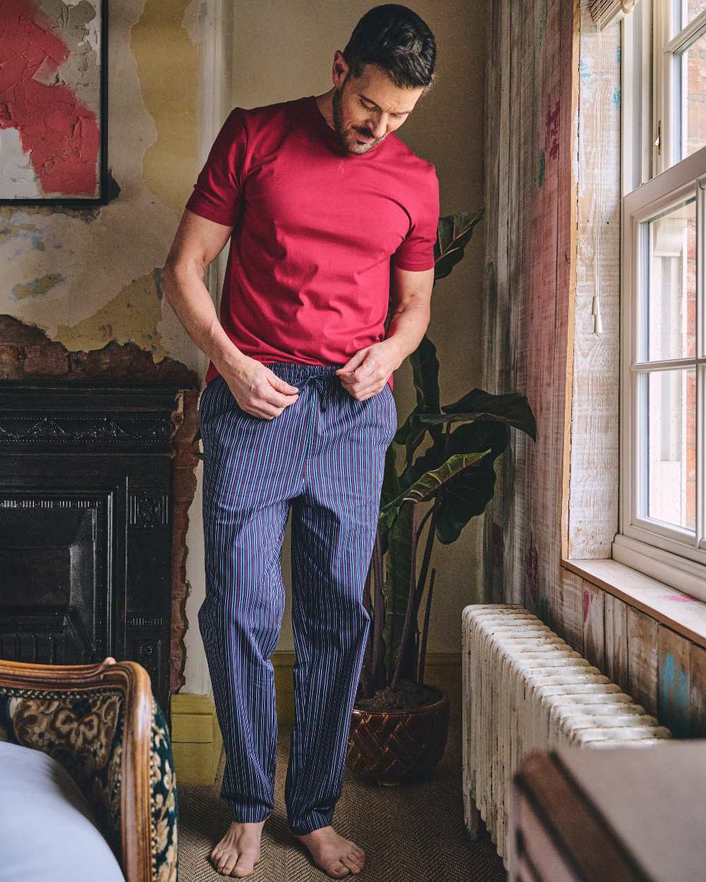 Red Navy Coloured HJ Hall Mens Crew Neck T-Shirt And Long Pyjamas Set on indoor background 