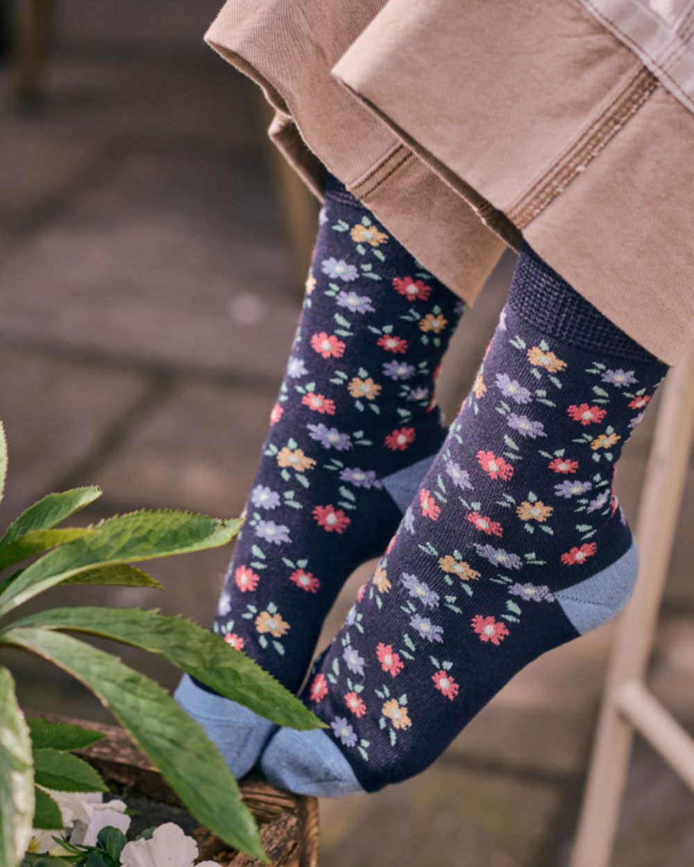 Navy coloured HJ Hall Womens Ditsy Floral Cotton Comfort Top Socks on garden background 