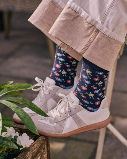 Navy coloured HJ Hall Womens Ditsy Floral Cotton Comfort Top Socks on garden background 
