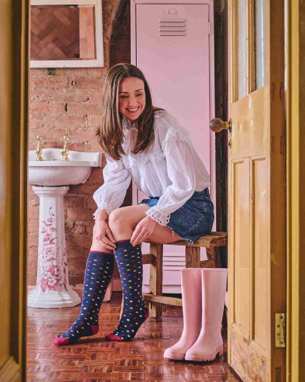 Navy coloured HJ Hall Womens Spot Welly Socks on house background 