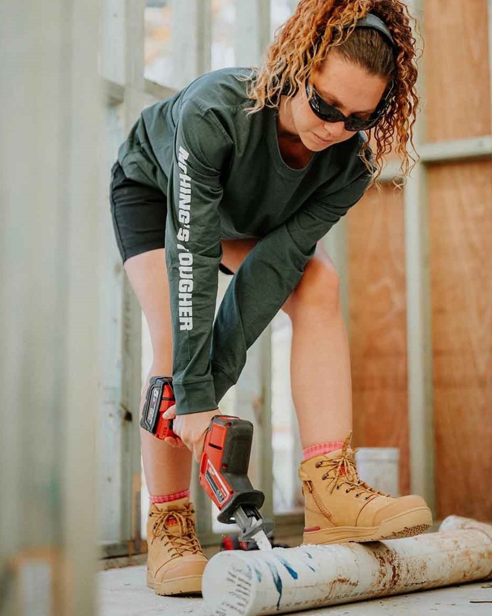 Green coloured Hard Yakka Heritage Long Sleeve T-Shirt on outdoor background 