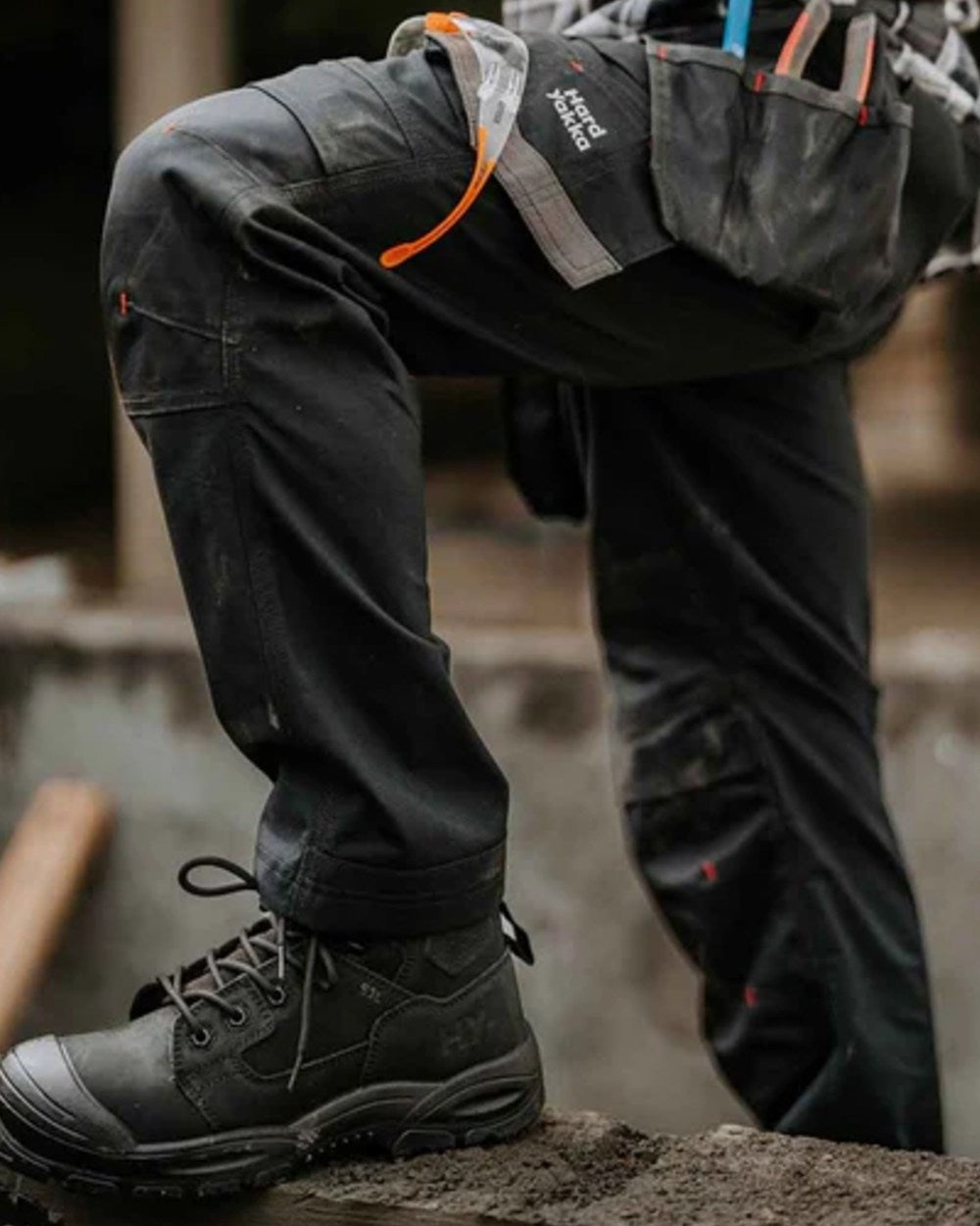 Black coloured Hard Yakka Legend S3 Safety Boots on outdoor background 