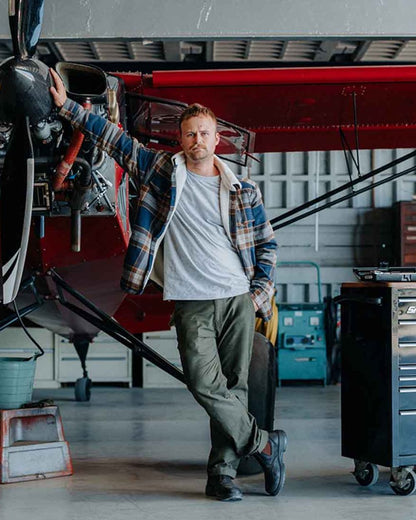 Forest coloured Hard Yakka Mens Heritage Carpenters Work Trousers on factory background 