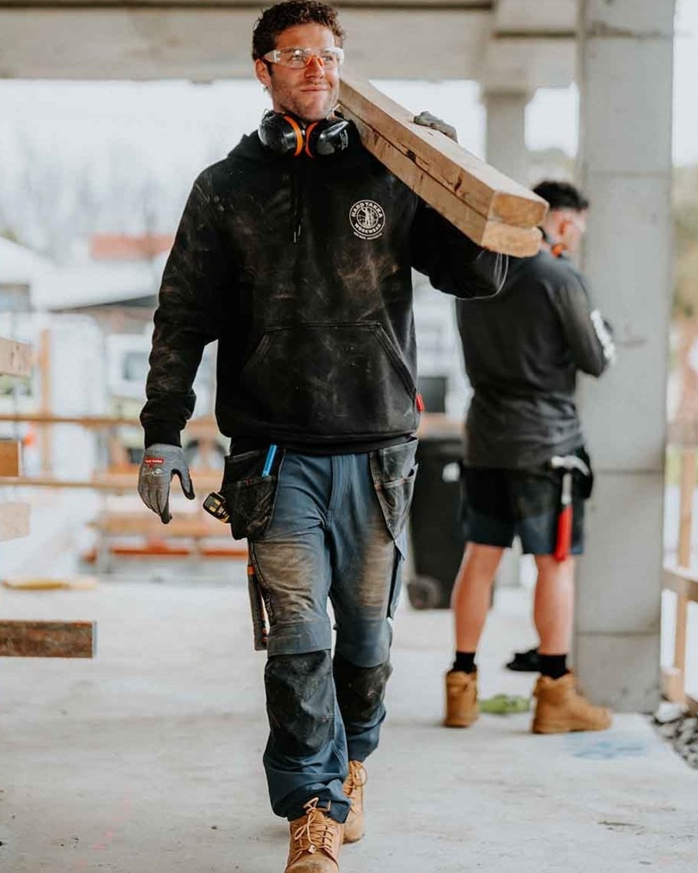 Black coloured Hard Yakka Mens Heritage Icon Hoodie on outdoor background 