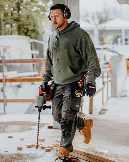 Military Green coloured Hard Yakka Mens Heritage Icon Hoodie on outdoor background 