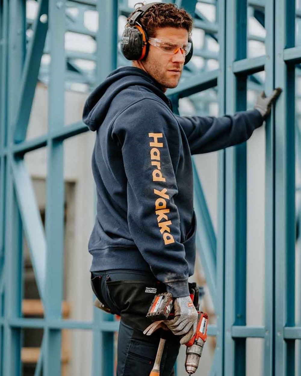 Navy coloured Hard Yakka Mens Heritage Icon Hoodie on outdoor background 
