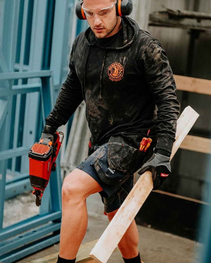 Black coloured Hard Yakka Mens Heritage Icon Lightweight Hoodie on back outdoor ground 