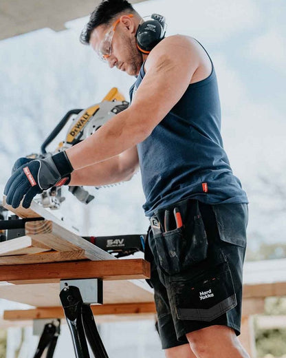 Navy coloured Hard Yakka Mens Heritage Icon Singlet on outdoor background 