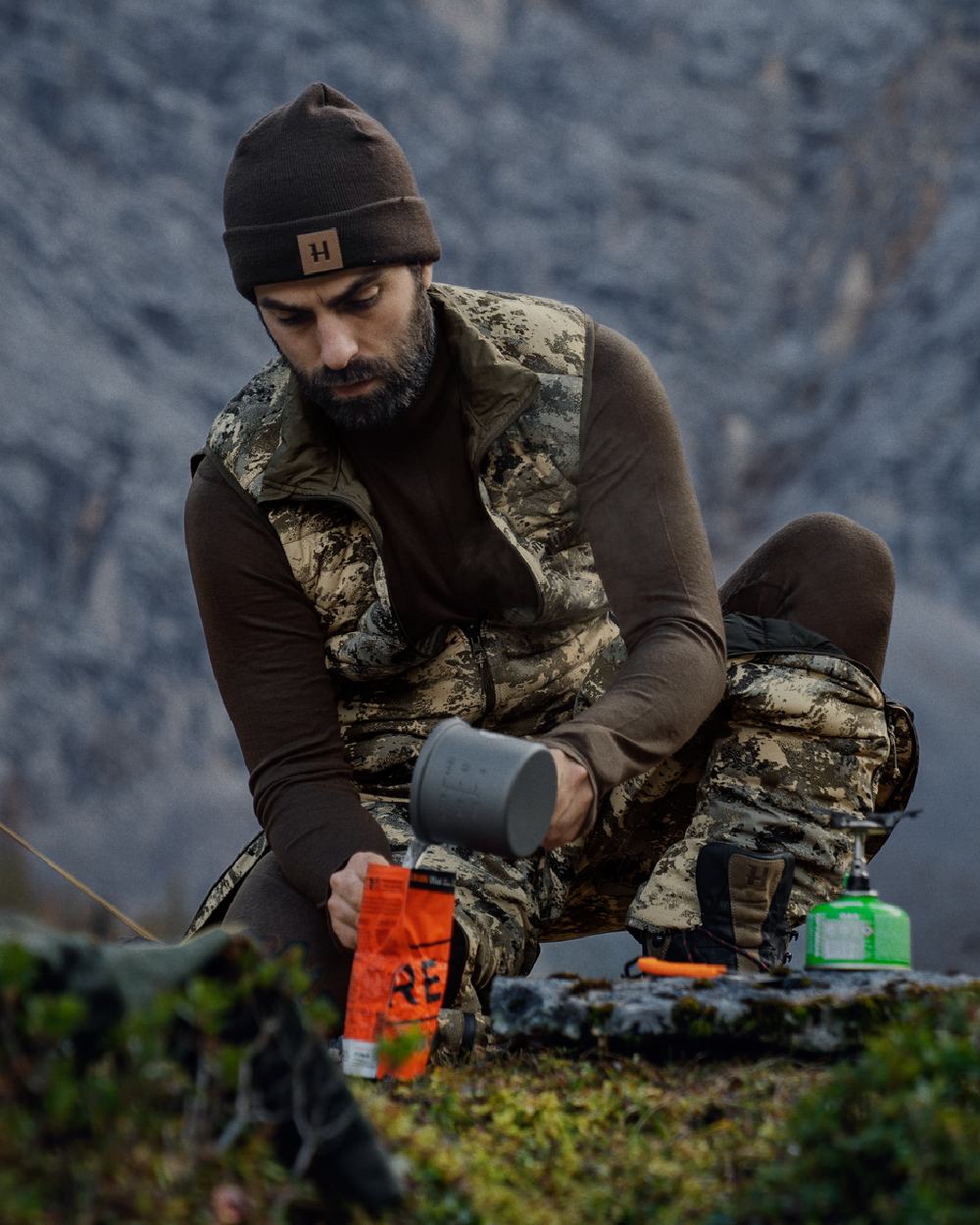 Shadow Brown Coloured Harkila All Season Half Zip Base Layer on mountain background 