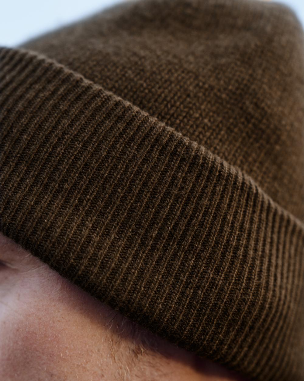Willow Green coloured Harkila Annaboda WSP Knit Beanie on forest background 
