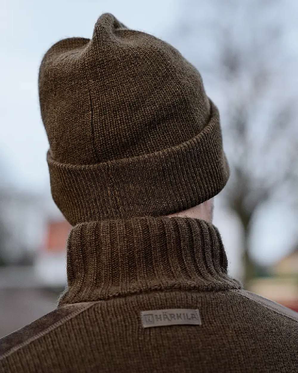 Willow Green coloured Harkila Annaboda WSP Knit Beanie on forest background 