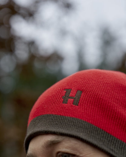 Shadow Brown Red Coloured Harkila Aspire Reversible Beanie on outdoor background 