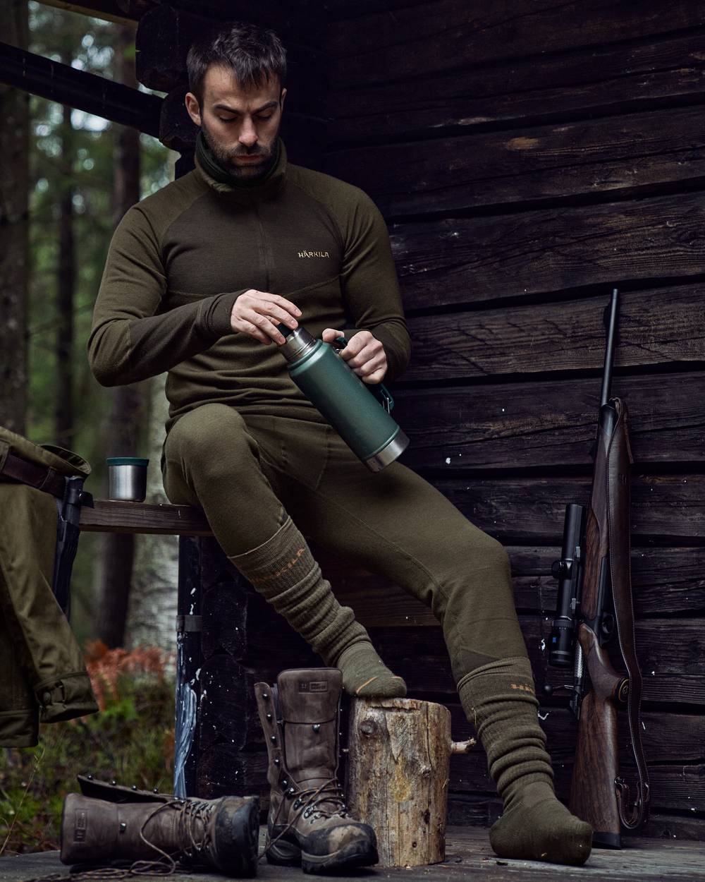 Willow Green Shadow Brown Coloured Harkila Base Warm Zip Neck on countryside background 