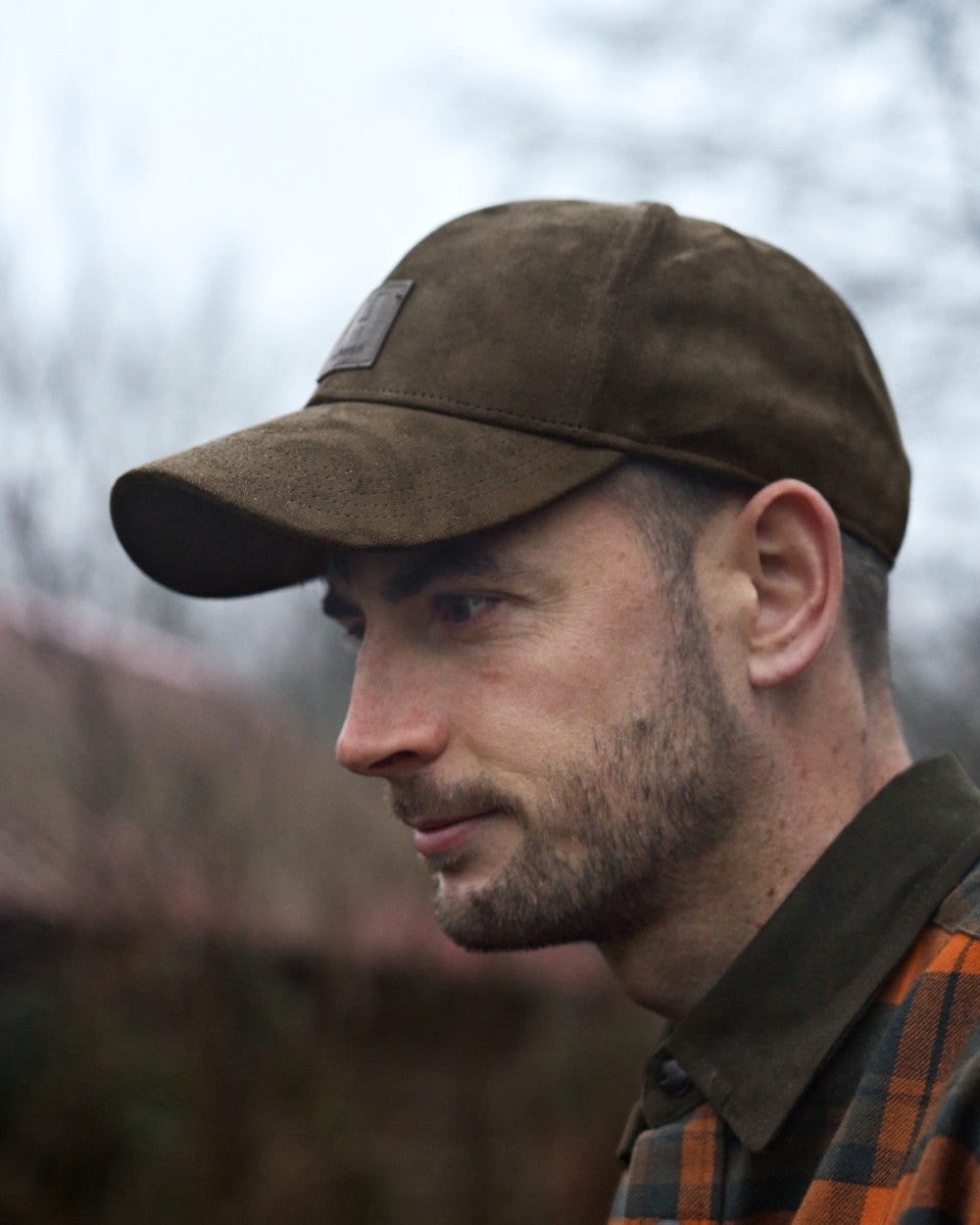 Hunting Green Coloured Harkila Berkshire Cap on outdoor background 