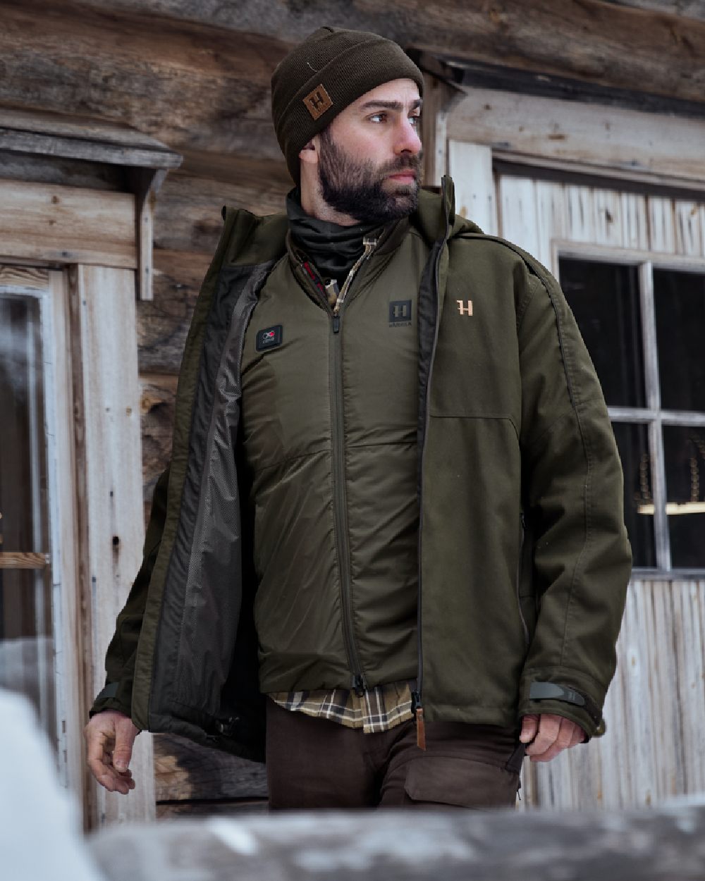 Willow Green Coloured Harkila Clim8 Base Waistcoat on house background 