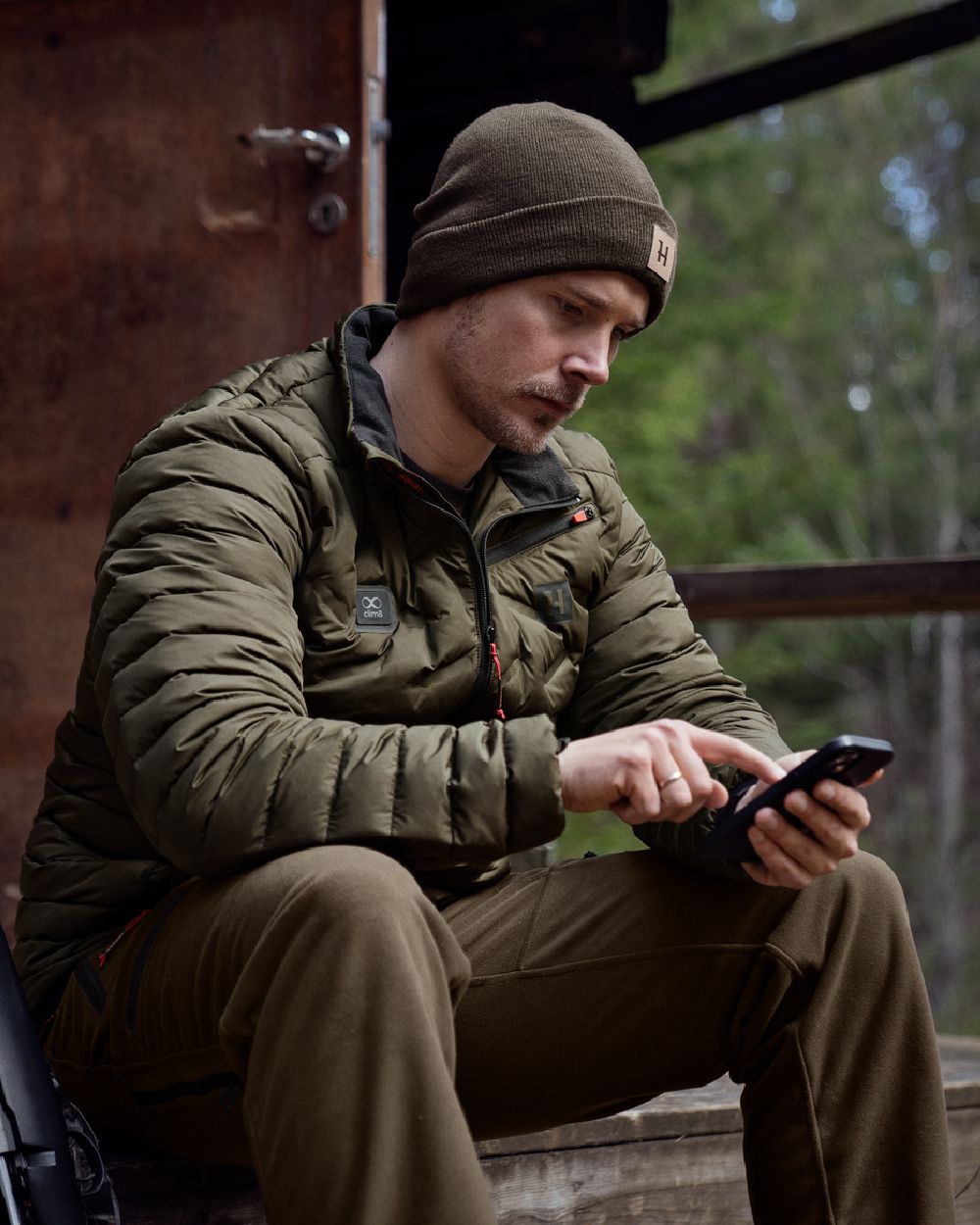 Willow Green Coloured Harkila Clim8 Insulated Jacket on outdoor background 