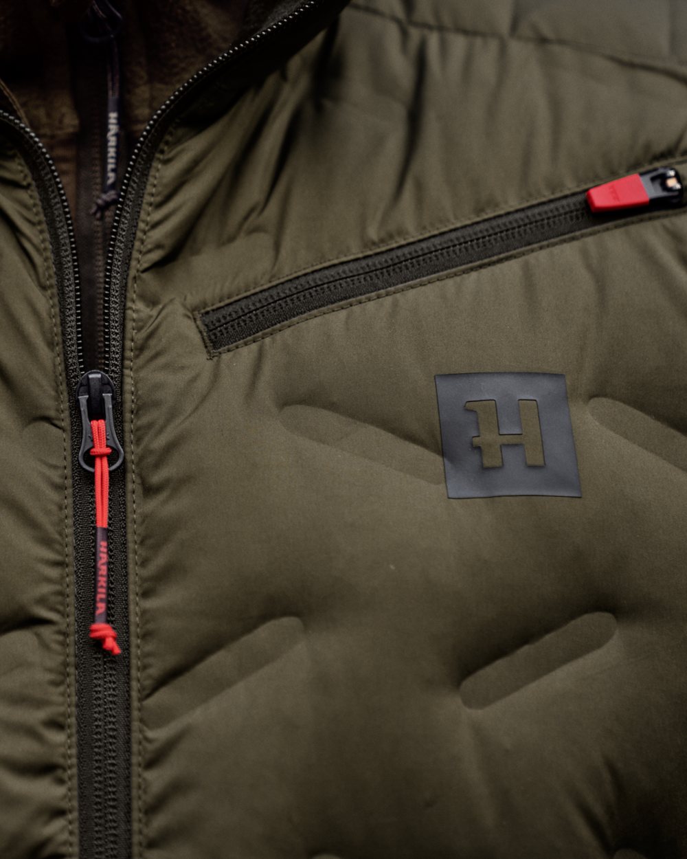 Willow Green Coloured Harkila Clim8 Insulated Waistcoat on outdoor background 