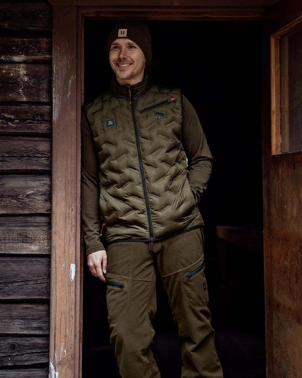 Willow Green Coloured Harkila Clim8 Insulated Waistcoat on outdoor background 