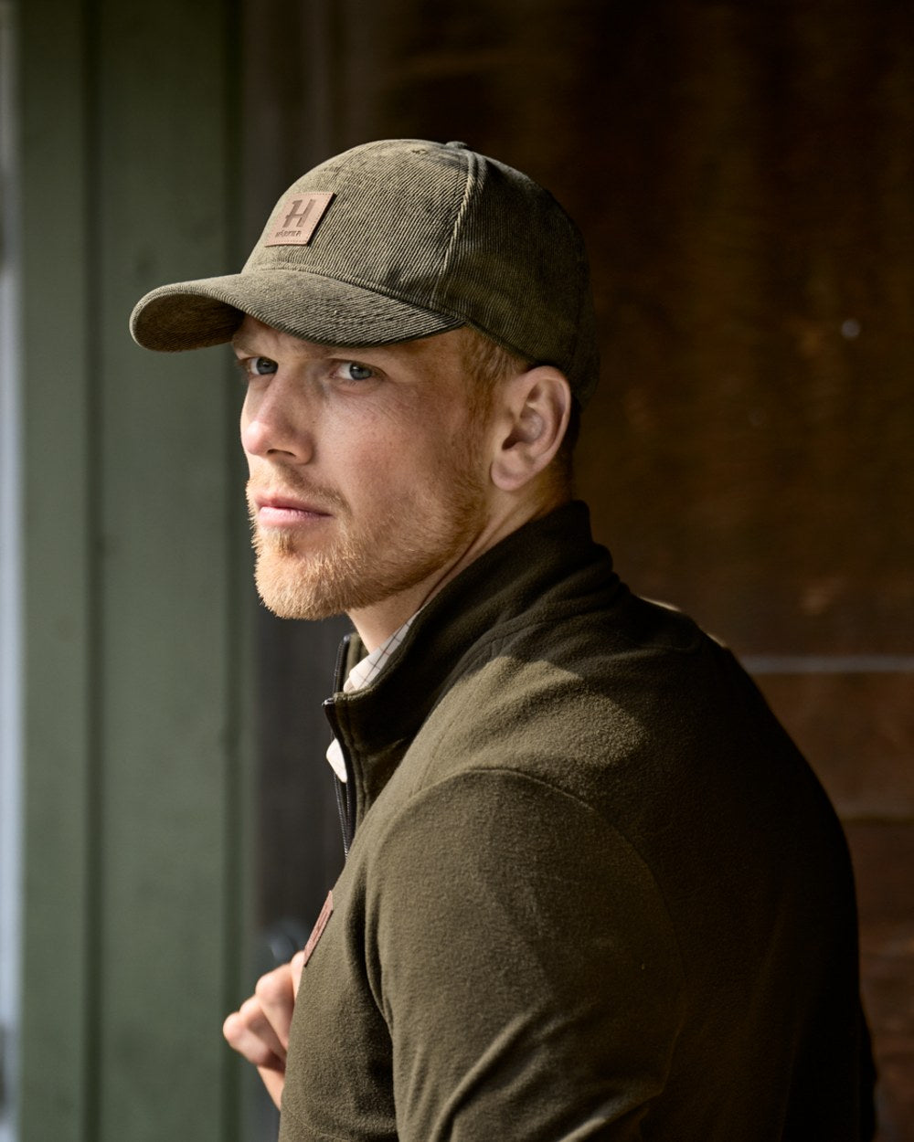 Grape Leaf coloured Harkila Corduroy Cap on barn background 
