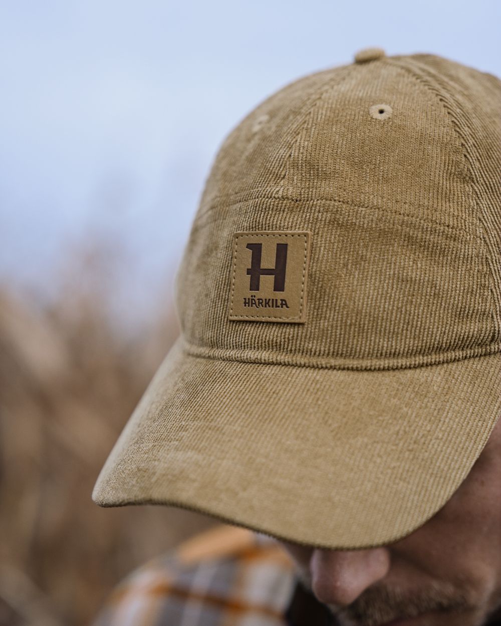 Elmwood coloured Harkila Corduroy Cap on outdoor background 