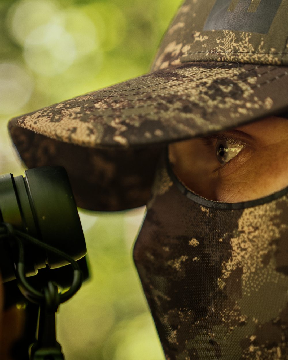AXIS Forest Coloured Harkila Deer Stalker Camo Cap With Mesh on blurry background 