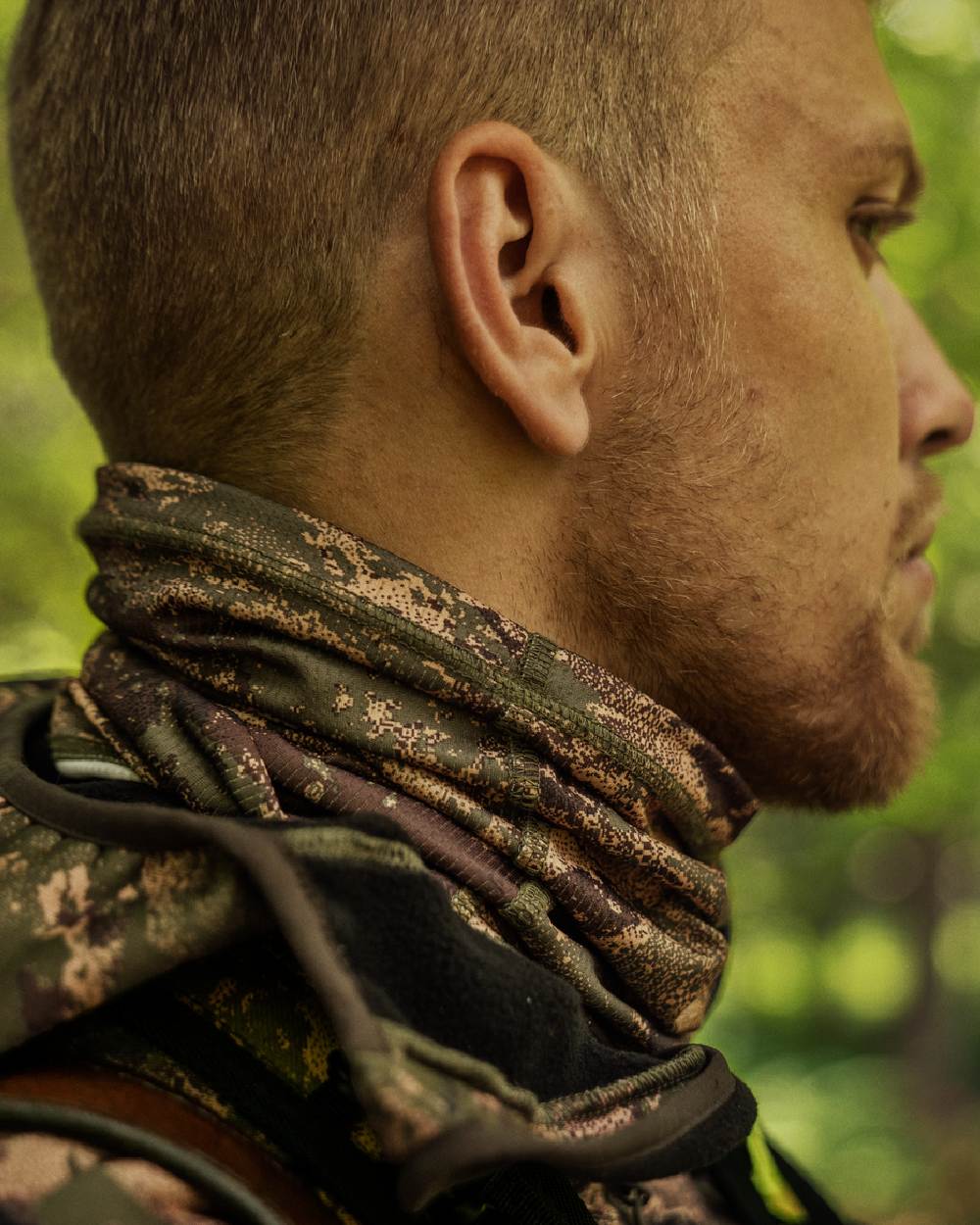 AXIS Forest Coloured Harkila Deer Stalker Camo Neck Gaiter on blurry background 