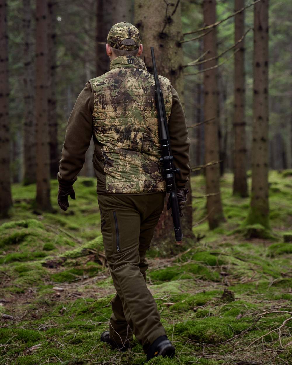Willow Green AXIS Forest Coloured Harkila Deer Stalker Camo Reversible Packable Waistcoat on forest background 