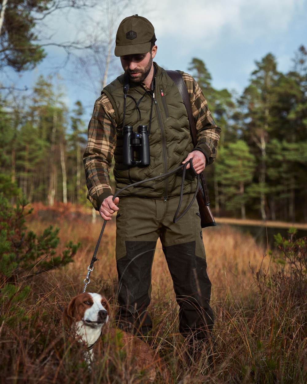 Willow Green Shadow Brown Coloured Harkila Driven Hunt HWS Leather Trousers on forest background 