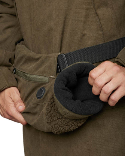 Willow Green Coloured Harkila Driven Hunt Heat Muff on white background 