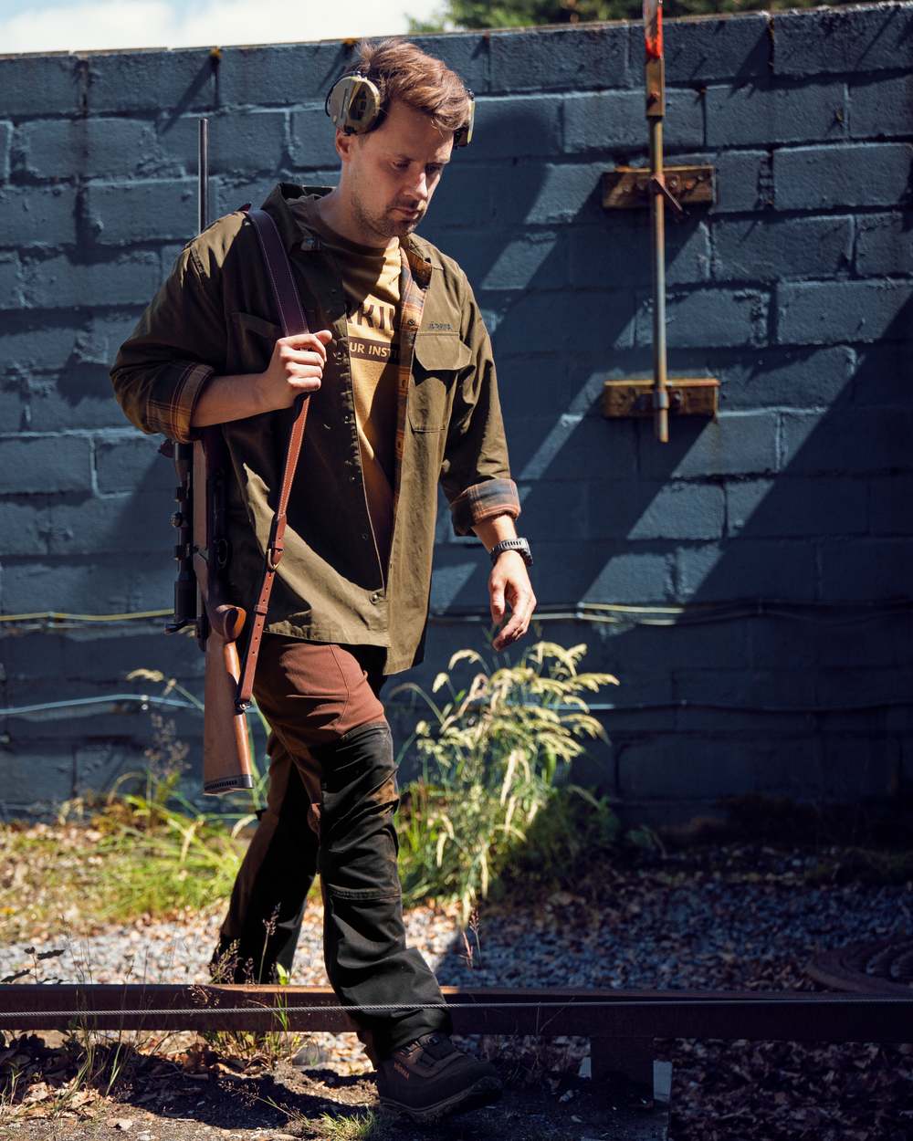 Dark Warm Olive Burgundy Coloured Harkila Eirik Reversible Shirt Jacket on countryside background 