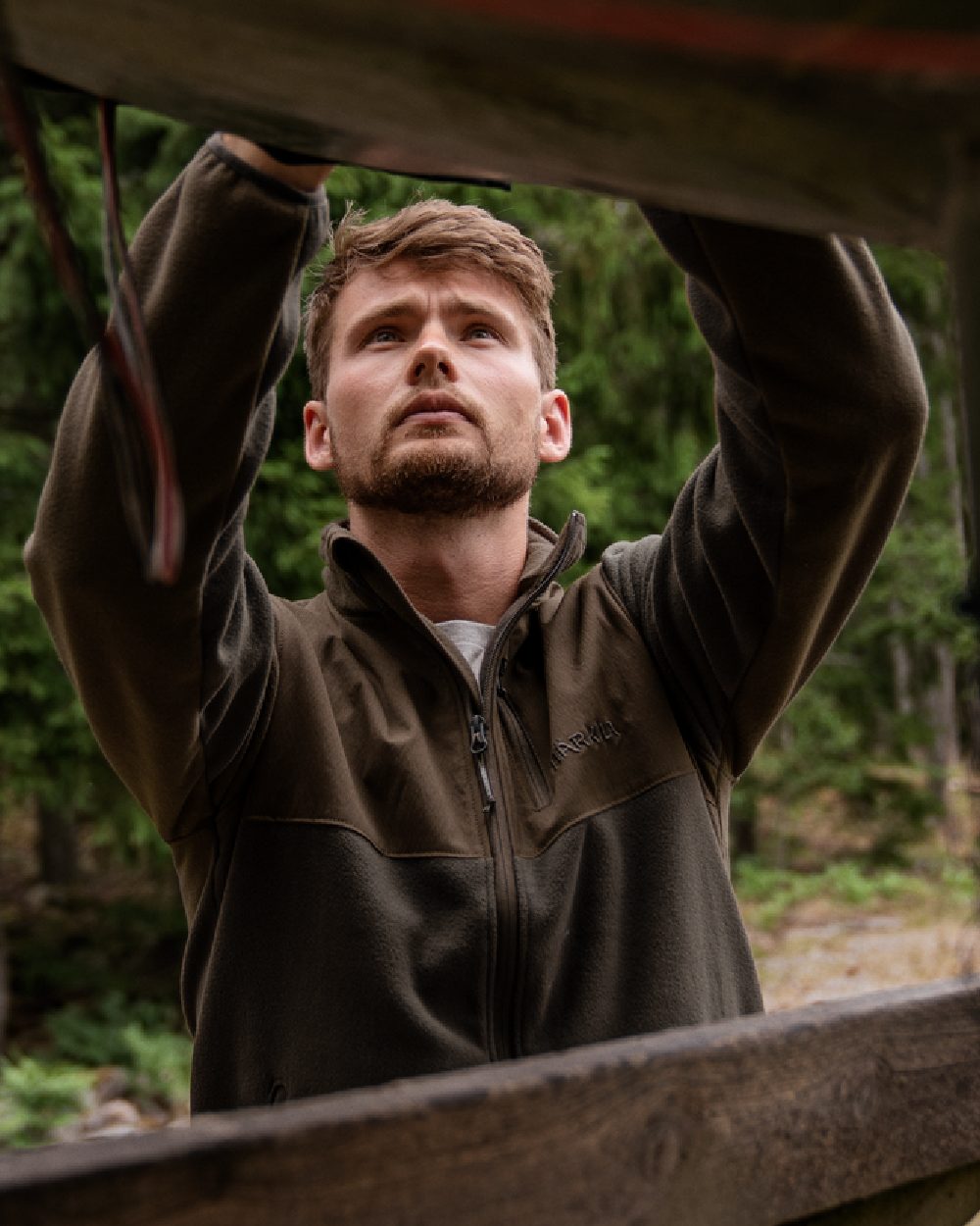 Shadow Brown Coloured Harkila Fjell Fleece Jacket on forest background 