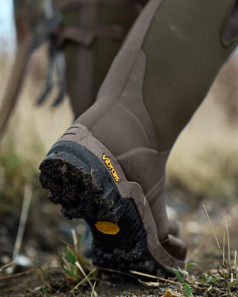 Willow Green Deep Brown Coloured Harkila Forester Zip Rubber Boot on outdoor background 