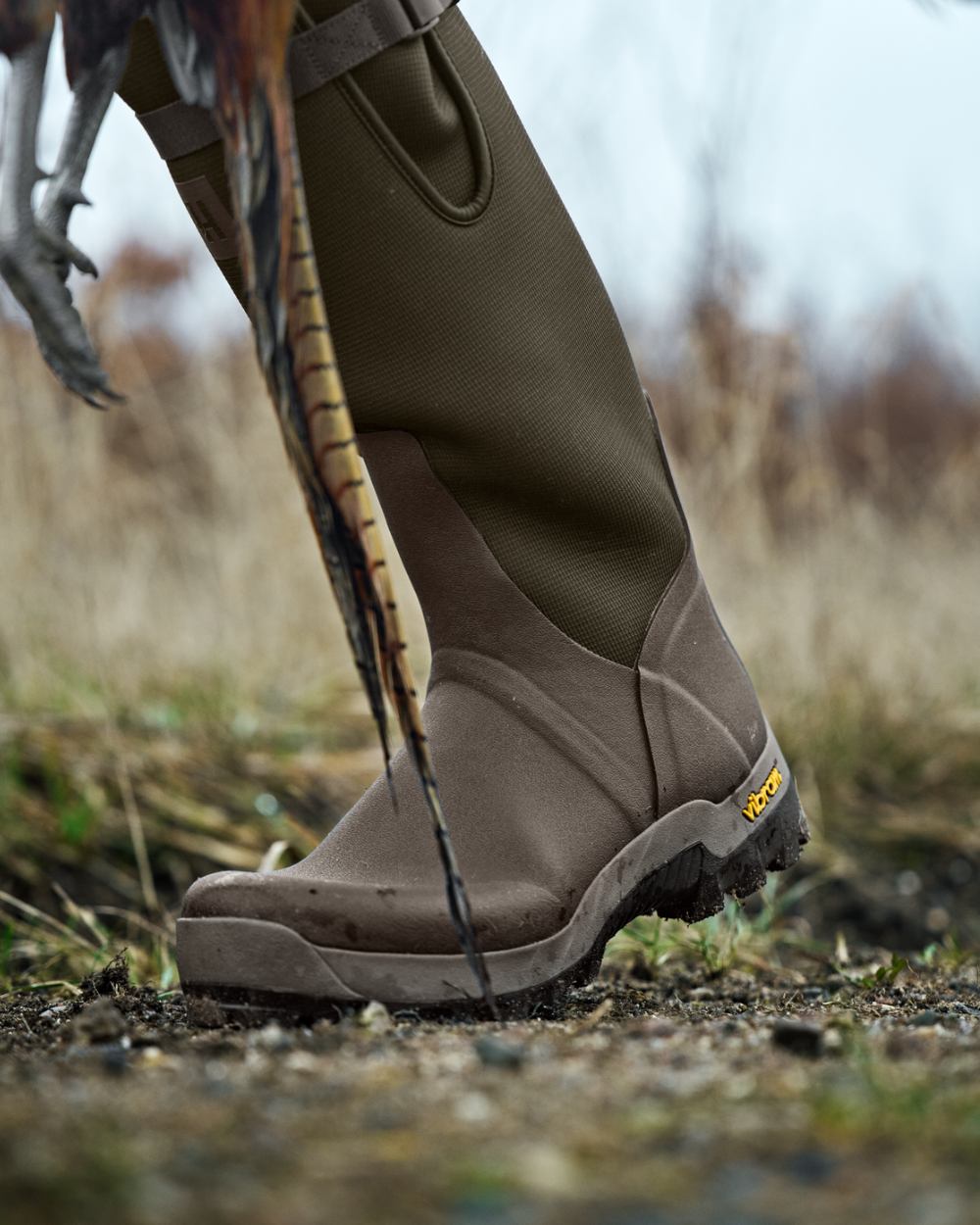 Willow Green Deep Brown Coloured Harkila Forester Zip Rubber Boot on outdoor background 