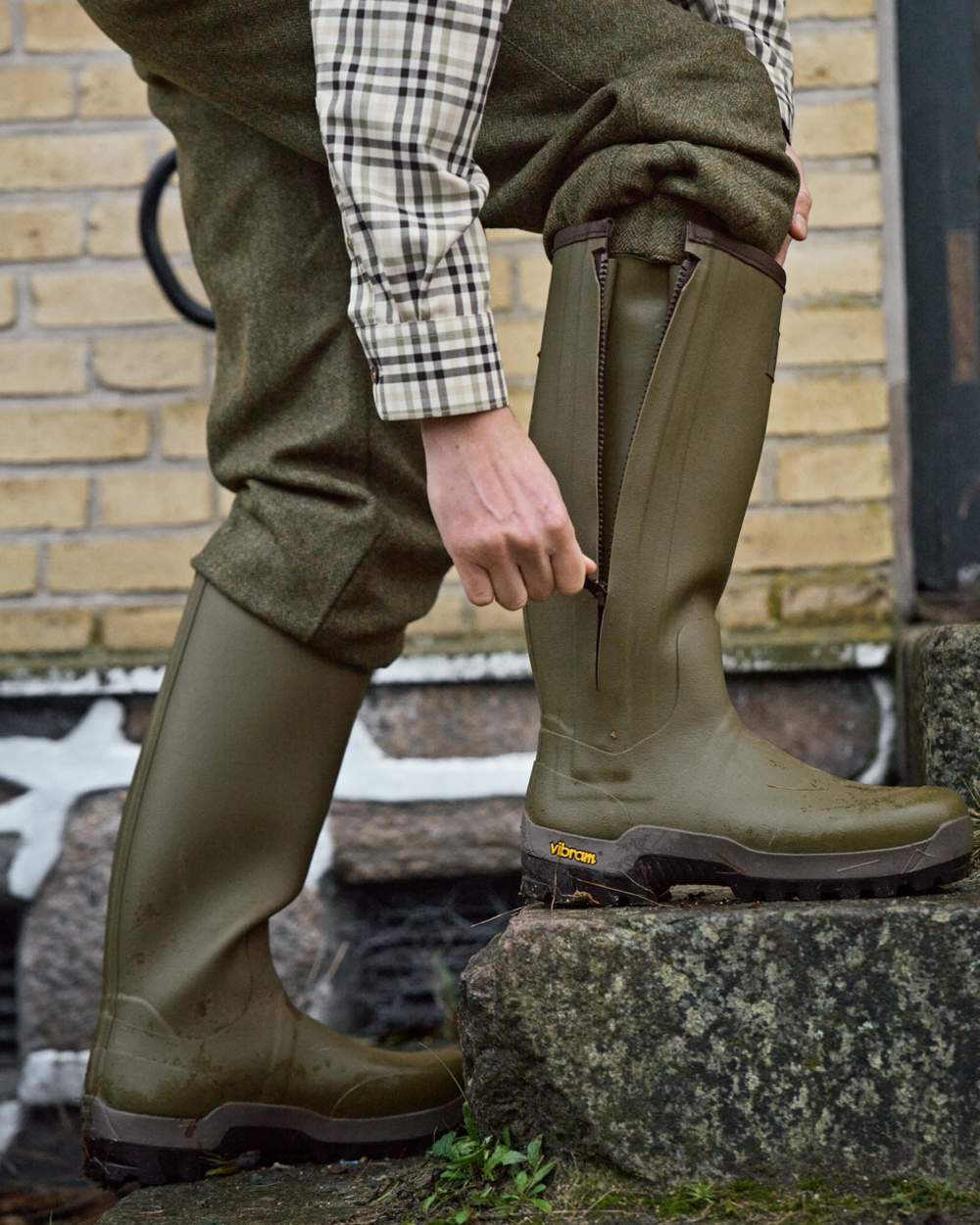 Dark Olive Coloured Harkila Forester Zip Rubber Boot on outdoor background 