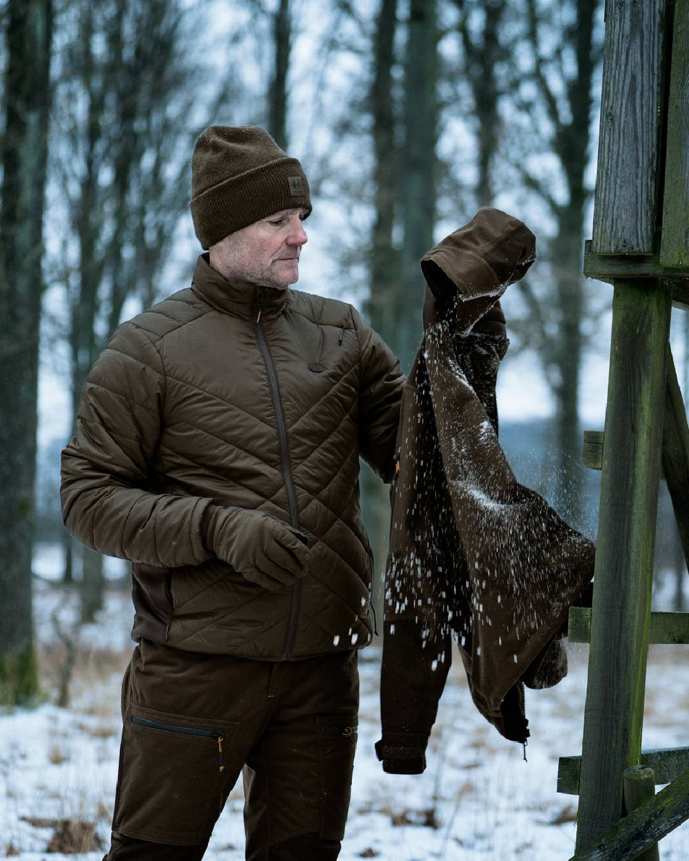 Willow Green Shadow Brown coloured Harkila Heat Insulated Jacket on forest background 