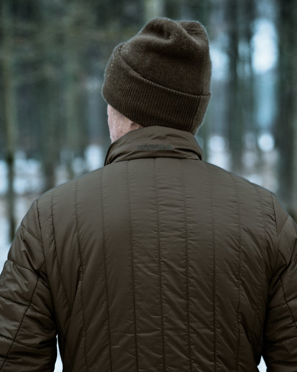 Willow Green Shadow Brown coloured Harkila Heat Insulated Jacket on forest background 