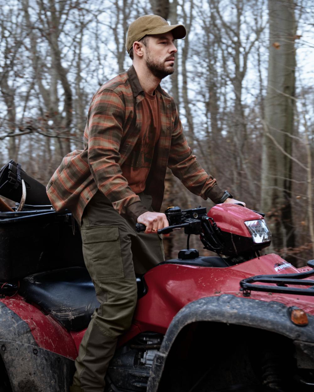 Black Olive Forest Night coloured Harkila Hill Trousers on outdoor background 