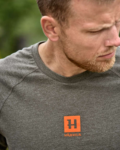 Green Melange coloured Harkila Instinct Short Sleeve T-Shirt on forest background 