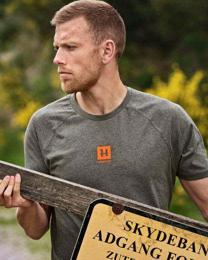 Green Melange coloured Harkila Instinct Short Sleeve T-Shirt on forest background 