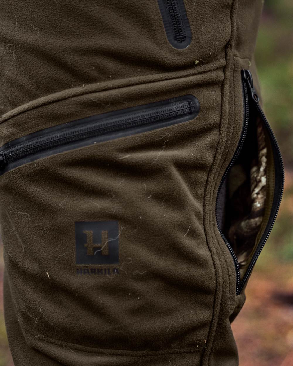 Hunting Green MossyOak Coloured Harkila Kamko Camo Reversible WSP Trousers on outdoor background 