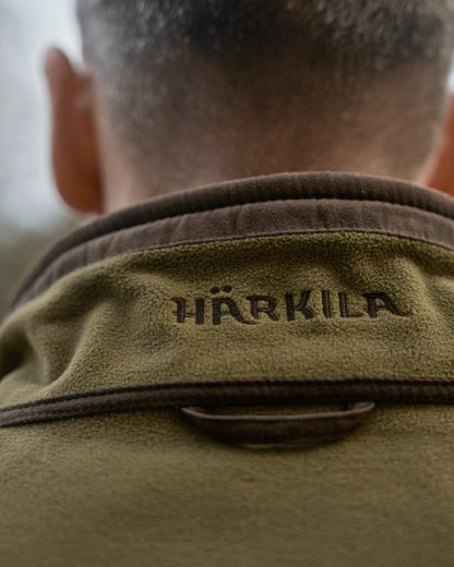 Dark Olive Sea Blue Coloured Harkila Kamko Estate WSP Reversible Waistcoat on outdoor background 