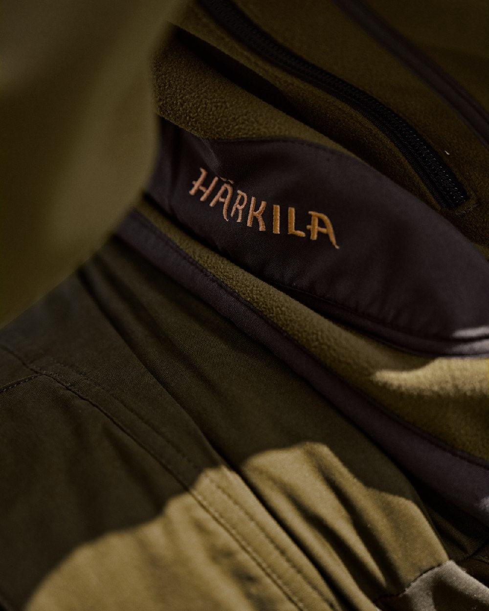 Dark Olive Arabian Spice Coloured Harkila Kamko Fleece on outdoor background 