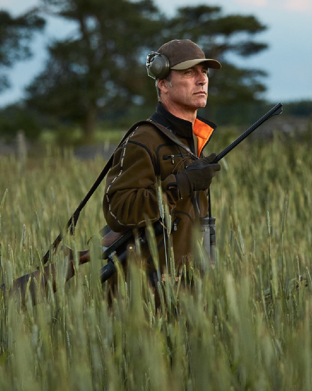 Hunting Green Orange Blaze Coloured Harkila Kamko Fleece on outdoor background 