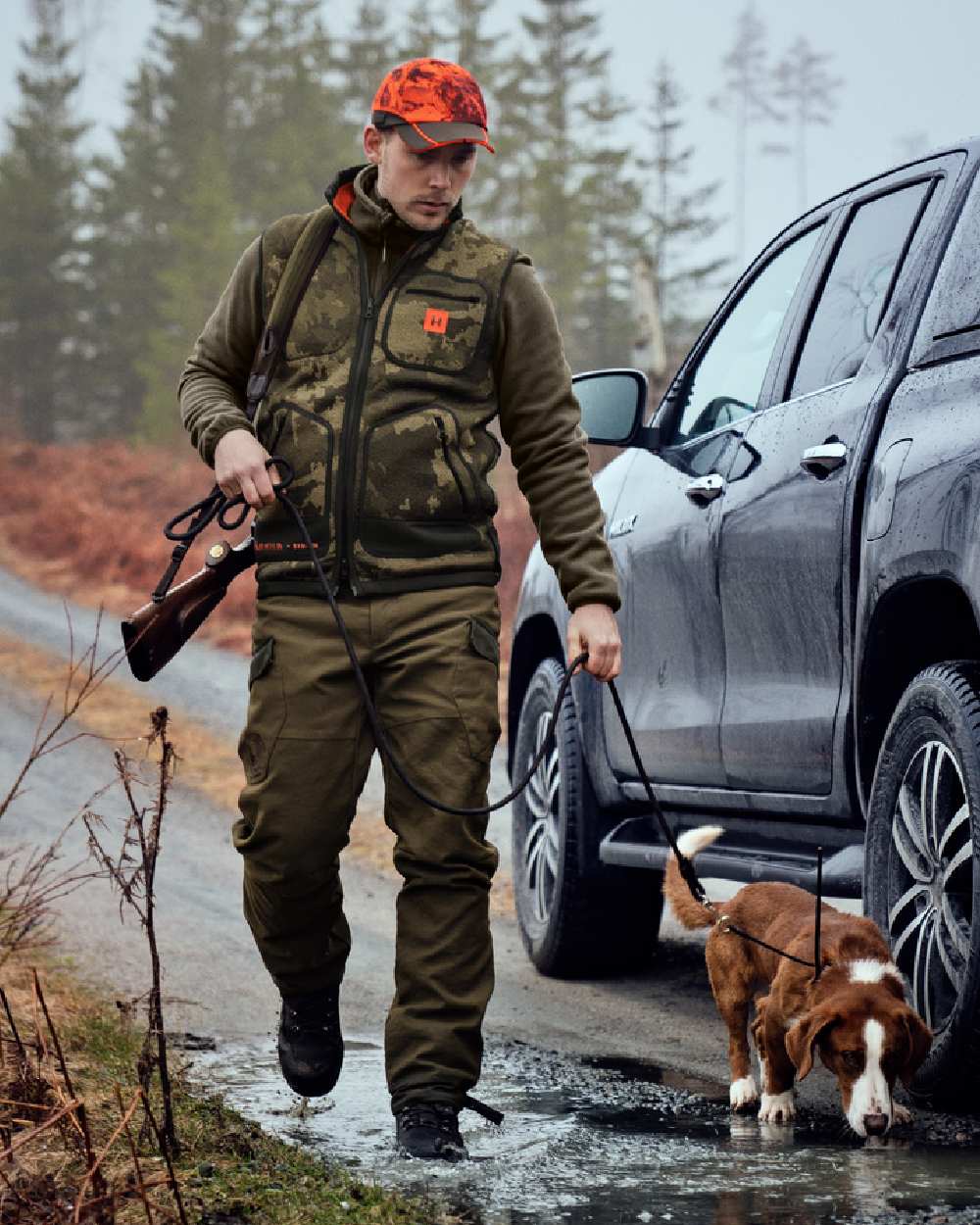 AXIS Limited Edition Orange Coloured Harkila Kamko Pro Edition Reversible Hi-Vis Waistcoat on forest background 