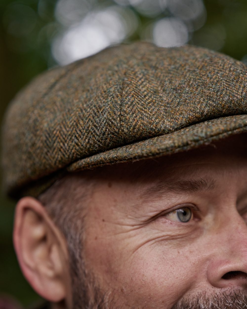 Forest Green Herringbone Coloured Harkila Kenmore Classic Baker Boy Cap on forest background 