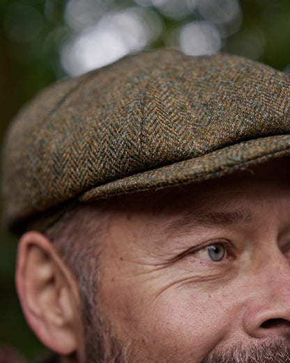 Forest Green Herringbone Coloured Harkila Kenmore Classic Baker Boy Cap on forest background 