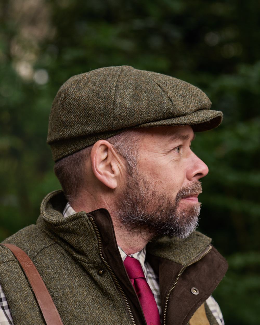 Forest Green Herringbone Coloured Harkila Kenmore Classic Baker Boy Cap on forest background 