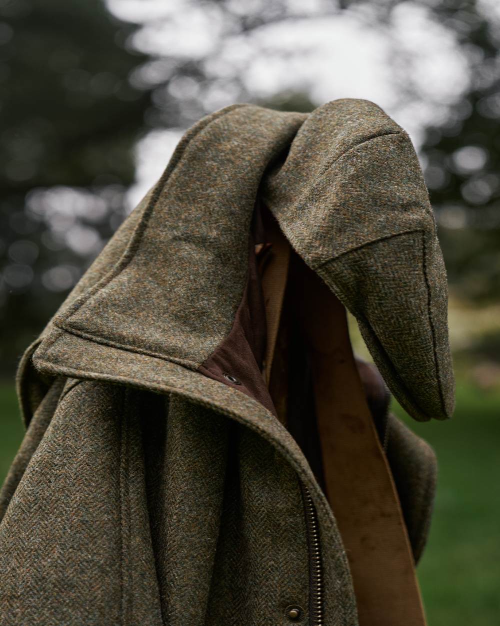 Forest Green Herringbone Coloured Harkila Kenmore Classic Flat Cap on outdoor background 