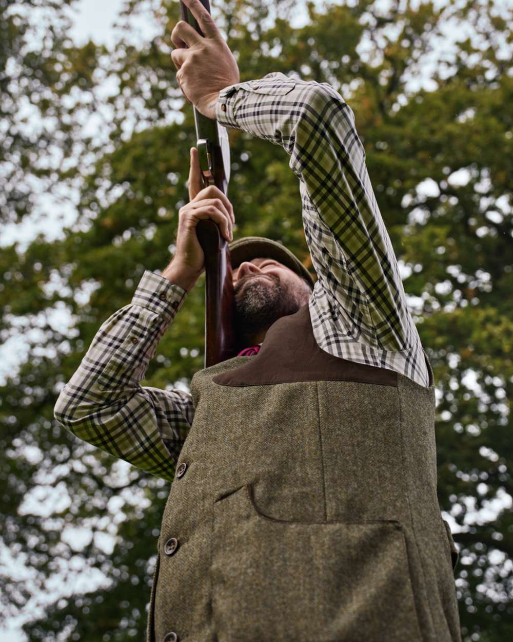 Forest Green Herringbone coloured Harkila Kenmore Shooting Waistcoat on forest background 